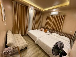 a bedroom with a bed with a cat laying on it at Hoàng Gia Villa in Phan Rang–Tháp Chàm