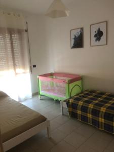 a bedroom with a bed and a green dresser at Civico 82 in Hermada