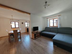 a living room with a couch and a table at Großberghof in Taxenbach