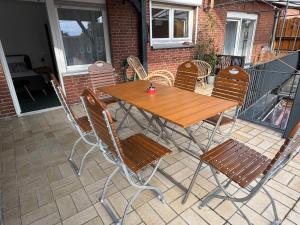 a wooden table and chairs on a patio at Casa Maria in Goch