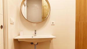 a bathroom with a sink and a mirror on the wall at LUXURY APARTMENT SCIENCES CITY Valencia B in Valencia