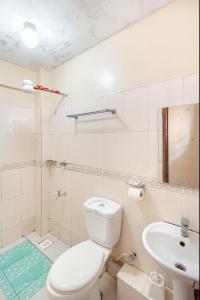 a white bathroom with a toilet and a sink at NOVA Stays, Luxe 1BR apartment, South B in Nairobi