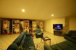 a living room with couches and a flat screen tv at Neruda Hotel in Kalkan