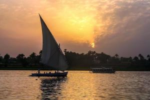 a group of people on a sail boat in the water at Felucca Alaska in Aswan