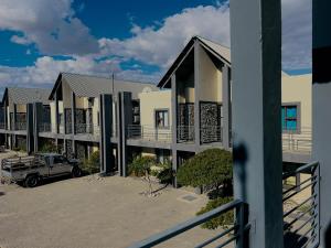 a building with a truck parked in a parking lot at Lighthaus44 in Ongwediva