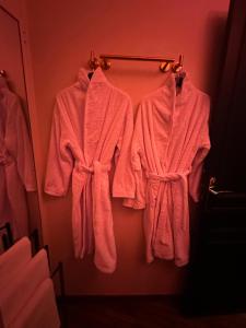 three towels are hanging on a rack in a bathroom at Love Horizons - Suite vue panoramique - Spa privatif - Rennes Centre in Rennes +50 photos