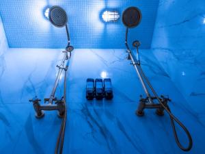 a blue bathroom with a shower with two lights at Love Horizons - Suite vue panoramique - Spa privatif - Rennes Centre in Rennes
