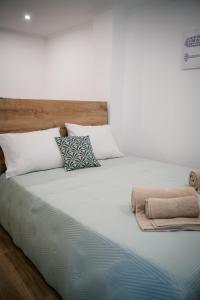 a large bed with two pillows on top of it at Riad'a Praia in Armação de Pêra