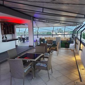 a restaurant with tables and chairs on a patio at S&J Luxury Homes Mombasa in Mombasa