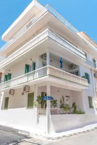 a white building with a balcony on a street at 5 steps from the sea in Kalamata