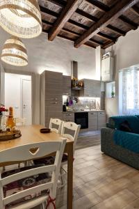 a kitchen and living room with a table and chairs at La casina delle 6M in Florence