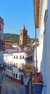 a view of a street with potted plants and a clock tower at Benafique La casa del Ciprés Cortegana in Cortegana