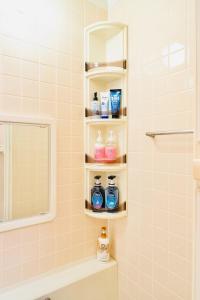 a bathroom with soap and toiletries on shelves at Kawagoe Inn Tokine - Vacation STAY 38137v in Kawagoe