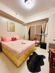 a bedroom with a large bed with pink pillows at Simoy Recharge Chamber in Kaybagal +12 photos