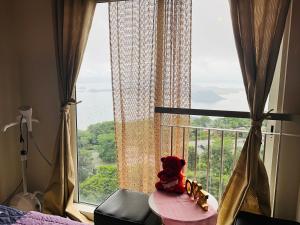a stuffed animal sitting on a table in front of a window at Simoy Recharge Chamber in Kaybagal