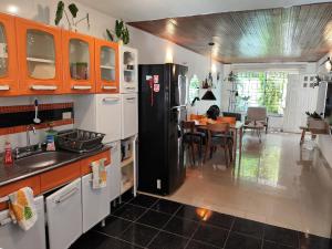 a kitchen with a black refrigerator and a table at Bona Vida Casa in Ríohacha