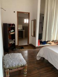 a bedroom with a bed and a room with a mirror at Beautiful Place in City centre in Abbottabad