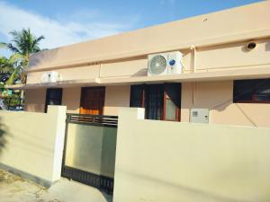 a house with a fan on the side of it at Canan suites in Trivandrum