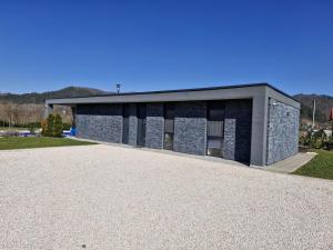 a building with a gravel driveway in front of it at Villa Stone House in Debeljaci