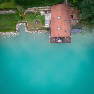 an aerial view of a building in the water at Rare petit chalet sur le lac barque à rames clim in Aiguebelette-le-Lac