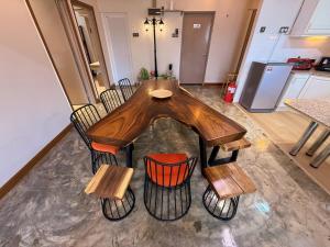 a wooden table and chairs in a kitchen at The Almost Touching the Stars Suite in Genting Highlands