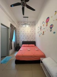 a bedroom with a red bed and a ceiling fan at Cameron 3room Golden Hills in Brinchang