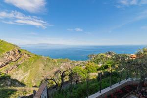 a view of the ocean from a hill at Taormina Sea View Apartment in Taormina