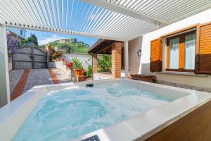 a large hot tub in the backyard of a house at Taormina Sea View Apartment in Taormina