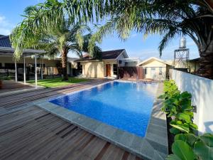 a swimming pool in the backyard of a house at RedDoorz Syariah Plus near Banyuwangi Airport in Dadapan