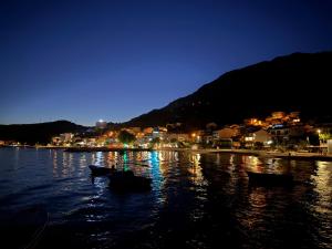 a river at night with boats in the water at Hostel Guesthouse Mira in Omiš