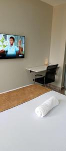 a room with a flat screen tv on the wall at Modern Cozy Studio in Nairobi