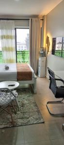 a bedroom with a bed and a table and chairs at Modern Cozy Studio in Nairobi