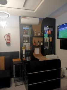 a barber shop with a tv on the wall at Grand Churchill Luxury Hotel in Orimedu