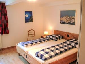 two twin beds in a room with a ladder at Apartment Living House Vandans by Interhome in Vandans