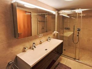 a bathroom with a sink and a shower at Apartment Living House Vandans by Interhome in Vandans