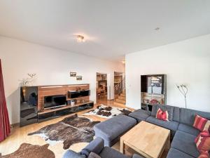 a living room with a couch and a tv at Apartment Living House Vandans by Interhome in Vandans