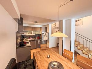 a living room with a kitchen and a staircase at Apartment Living House Vandans by Interhome in Vandans