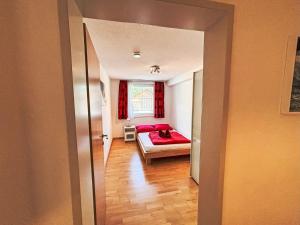 a bedroom with a bed with a red blanket at Apartment Living House Vandans by Interhome in Vandans +9 photos
