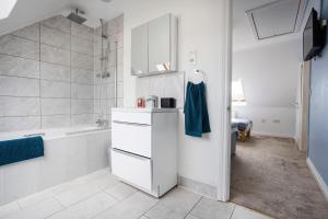 a white bathroom with a sink and a tub at Courtsknap Contractors Sleeps 9 Free Parking WiFi in Swindon +28 photos