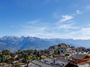 a view of a city with mountains in the background at Apartment Grand Panorama A11 by Interhome in Nendaz