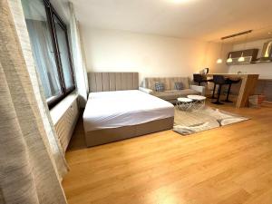 a bedroom with a bed and a couch and a table at NaturTraum Kniebis in Freudenstadt +2 photos