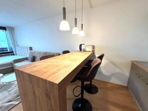 a wooden table in a living room with chairs at NaturTraum Kniebis in Freudenstadt