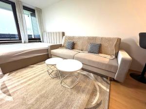 a living room with a couch and a table at NaturTraum Kniebis in Freudenstadt