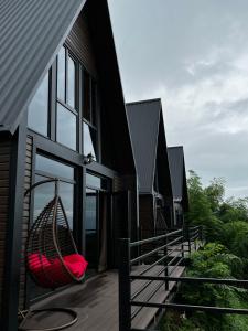 a hammock hanging on the side of a house at Kvirike Hills Cottages in K'obulet'i