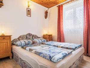 a bed in a room with a large window at Holiday Home Sunny by Interhome in Balatonőszöd