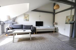 a living room with a couch and a table at Worker & families Dream Apartment in the heart of Gothenburg in Gothenburg