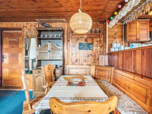a dining room with a table and a kitchen at Chalet Vesec by Interhome in Vesec