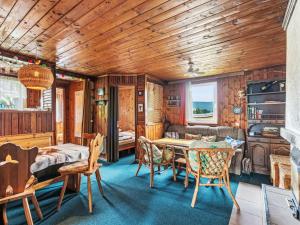 a room with a table and chairs in a cabin at Chalet Vesec by Interhome in Vesec