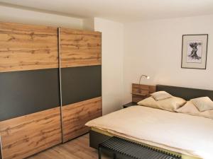 a bedroom with a bed and a wooden wall at Apartment Frieda by Interhome in Zams