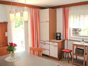 a kitchen with a table and a refrigerator and a dining room at Apartment Frieda by Interhome in Zams